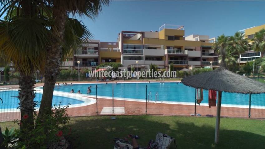 Modern apartment for sale in a gated residential complex with a swimming pool
